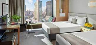 A living room filled with furniture and a large window  Description generated with very high confidence